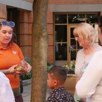 Guests learn from John Ball Zoo partner holding a tortoise